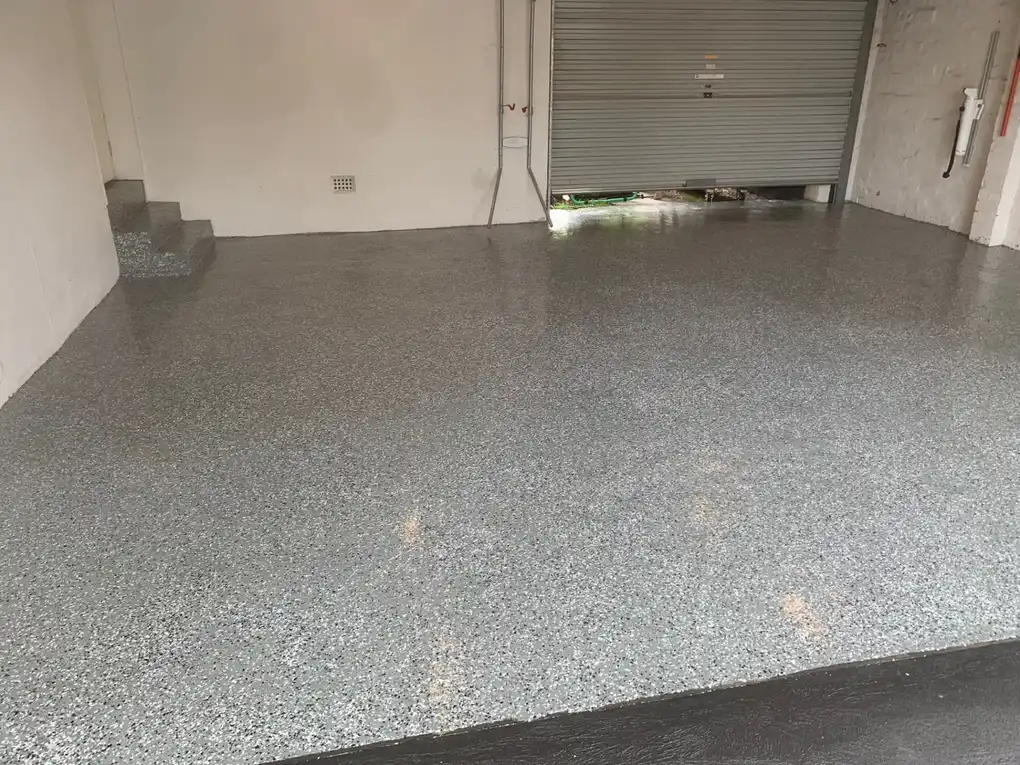 Durable epoxy garage floor coating completed for residential home with smooth and easy to clean finish.
