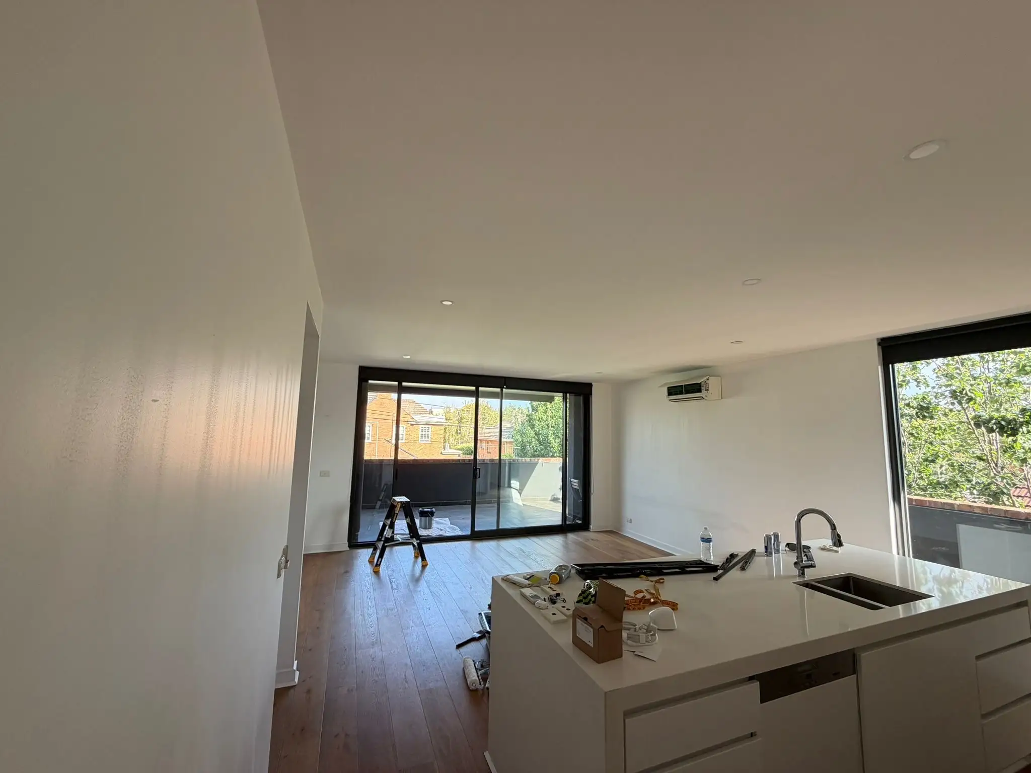 Protective coating applied during residential home renovation project for durable and modern finish.