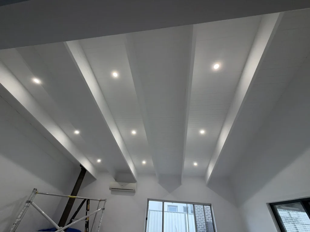 Freshly painted white ceiling beams with downlights – residential interior painting Melbourne by Ace Coating Services