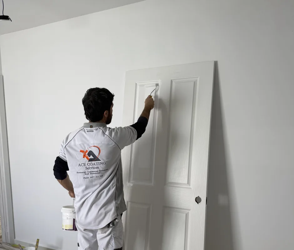 Ace Coating Services painter carefully painting an interior door during a Melbourne house repaint